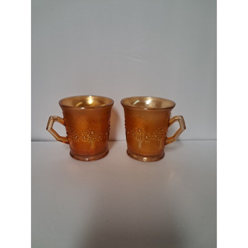 Set Of 2 Amber Colored Mugs. With Orange Trees Around It